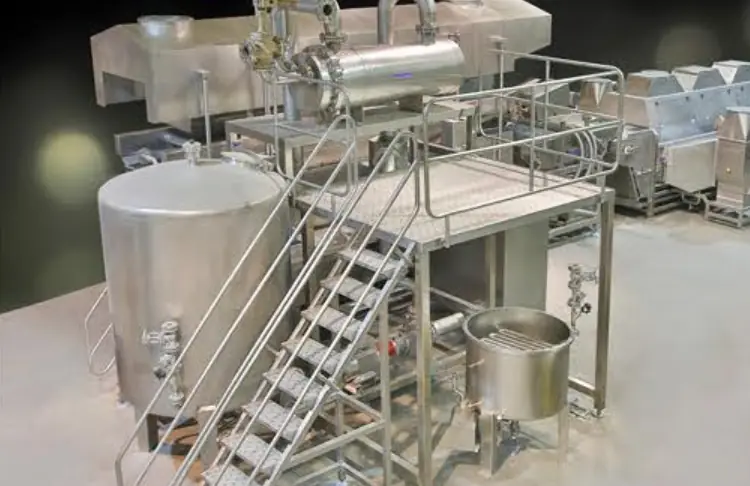 Stainless steel cooking kettles with service platform and stairs in a Bigtem line