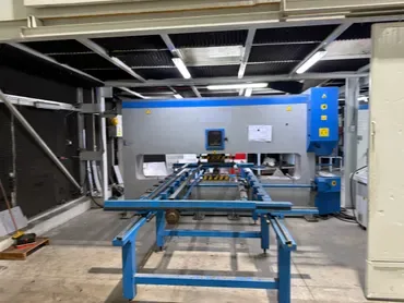 Sheet metal processing machine with infeed table in the fabrication shop