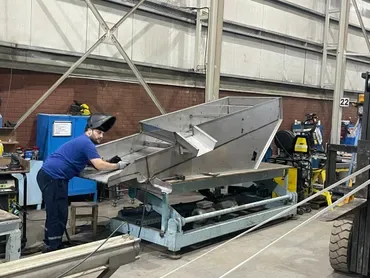 Bigtem welder fabricating a stainless steel hopper